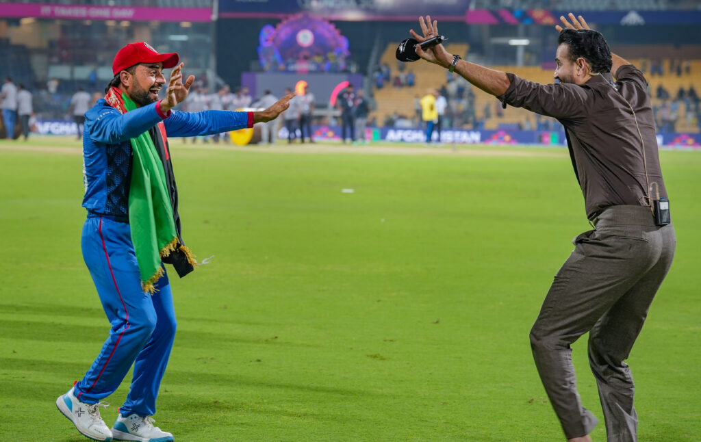 Afghanistan's Rashid Khan with commentator Irfan Pathan celebrates after winning 