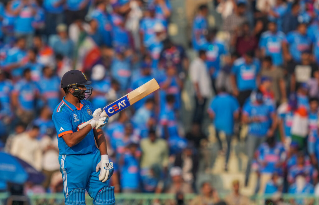  Indian captain Rohit Sharma celebrates his fifty during the Cricket World Cup 2023 match between India and England