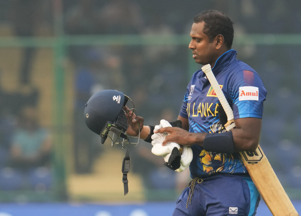 Sri Lankan batsman Angelo Mathews leaves the ground after being given 'timed out' by umpire during the ICC Cricket World Cup 2023 match between Sri Lanka and Bangladesh