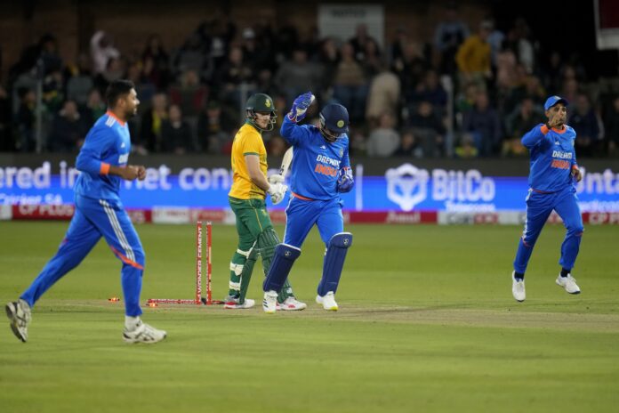 South Africa's David Miller, second left, reacts after he is bowled out by India's Varun Chakravarthy during the second T20 cricket match between South Africa and India at St George's Park in Gqeberha, South Africa, Sunday